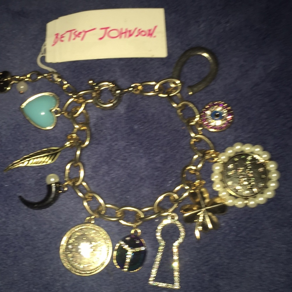 Gold betsey charm bracelet. All good luck charms